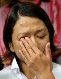 A former hostage cries after her release