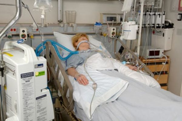 woman in intensive care unit with respirators