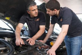 Father and son working on engine