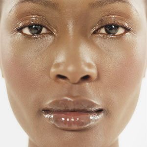 Close up of woman with shiny lips and face.