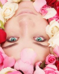 woman in tub of rose petals