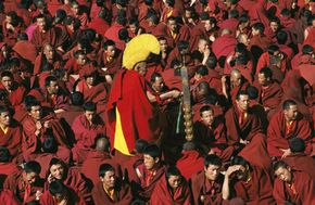 Tibet Image Gallery Buddhist Monks in Lhasa, Tibet wear maroon robes and distinctive yellow hats. See more pictures of Tibet.