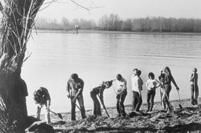 FBI agents dig in the sand on the north shore of the Columbia River where a portion of the D.B. Cooper hijack money was found.