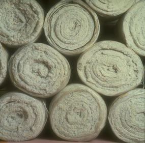 Rolls of natural cotton and recycled cotton prepared for use as an alternative to fiberglass insulation.