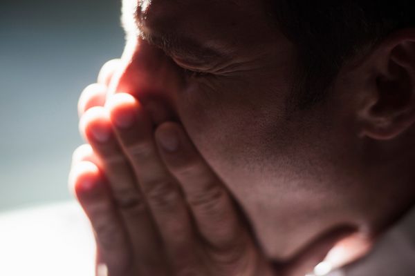 Man stifling sneeze