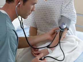 doctor taking patiets blood pressure