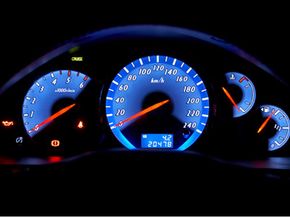 A car dashboard lit up at night