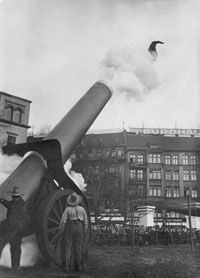 A human cannonball flies through the air after being fired from a cannon.