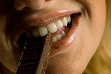Though a candy bar a day will almost certainly not keep the doctor away, dark chocolate, when eaten in moderation, can improve your dental health.