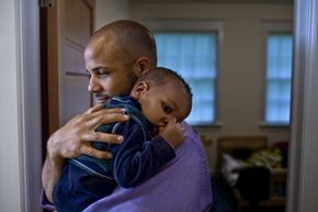 father holds child