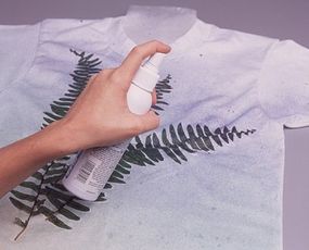 Spray the paint in a diagnol movement beginning at the lower right corner of the shirt.