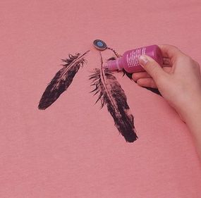 Sew on a silver button, and draw dots down the shaft of the feather using dimensional paint.
