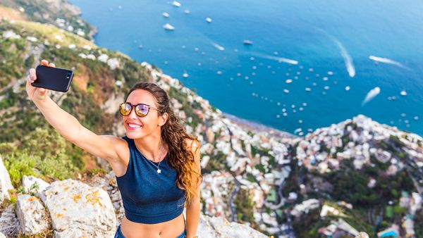 woman taking selfie on cliff