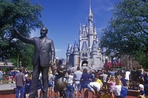 A statue of Walt Disney and Micky Mouse at the entrance to the magic kingdom at Disney World.
