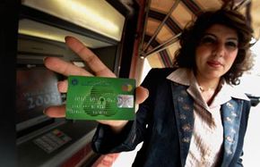 Banks in Baghdad have started issuing debit cards to customers, as advertised by this employee of Warka Bank on March 11, 2008.