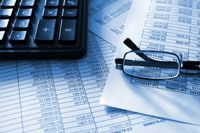 calculator and glasses on finance documents