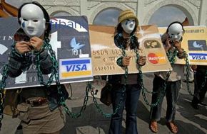 Local consumers who are in credit card debt, referred to as 'credit card slaves', take part in a demonstration calling for the government to pass a law to help people oweing money to banks, June 2, 2007, in Taipei.