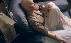 A young woman receives chemotherapy. 