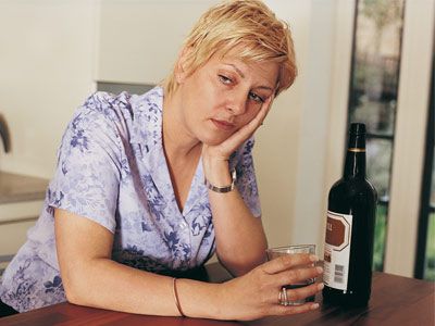sad woman with wine bottle