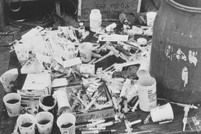 Guyanese officials found piles of paper cups with cyanide-laced fruit punch and syringes at Jonestown.