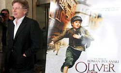 Roman Polanski poses next to the poster for his 2005 "Oliver Twist" film.”border=