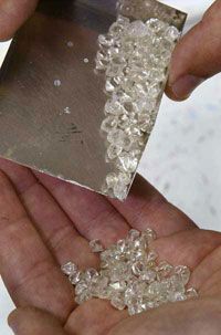 Rough diamonds in a hand.