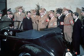 Adolf Hitler and other Nazi Officials admiring Hitler's 50th birthday present -- a Volkswagen convertible.