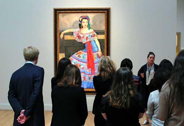 Men and women standing indoors for presentation.