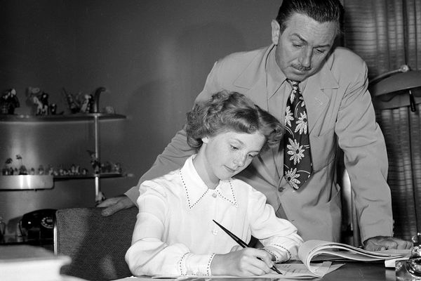 Men and women gathered around a black and white table.