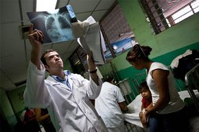 A doctor examines a chest x-ray of a child with severe pneumonia at the Oscar Danilo Rosales Hospital on July 31, 2009 in Leon, Nicaragua.