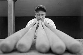 New York Yankee's power hitter Lou Gehrig looks over a few baseball bats. His name became associated with ALS after he was diagnosed with it in 1939.