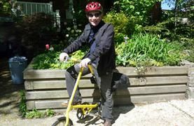 Person smiling while biking outdoors alone.