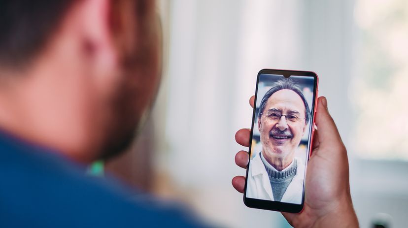 Patient at home talking to a doctor online through a mobile phone