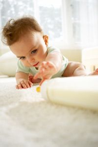 baby reaching for a bottle