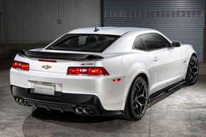 The 2014 Chevrolet Camaro Z/28 uses a dual exhaust system and large, three-inch-diameter pipes for low restriction. The optimized header and exhaust system improves torque and sound quality from the LS7 engine.