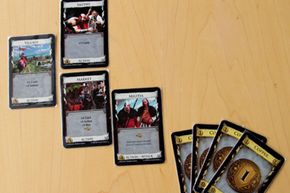 A few cards from Dominion laid out on a tabletop.