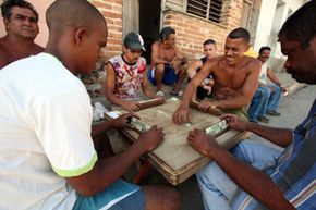 Men play dominoes on the sidewalk in Trinidad, Cuba in 2007.