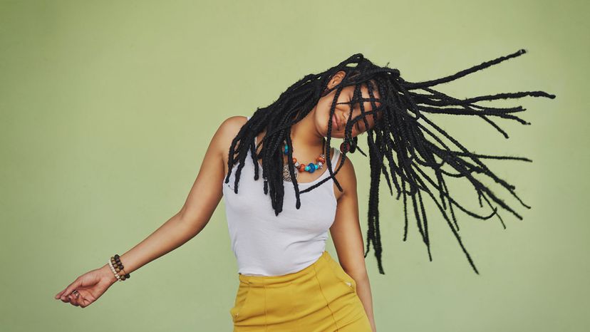 woman shaking dreadlocks