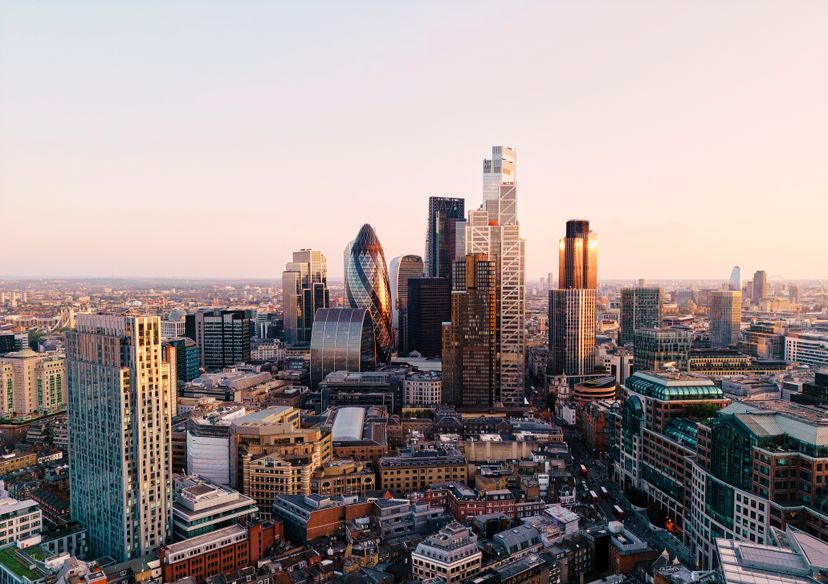 UK, London, elevated view over city financial district skyline at sunset