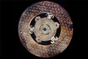 That's not a Dropa stone but rather a jade bi disk from the late Zhou dynasty. Such disks are relatively common in Chinese history.