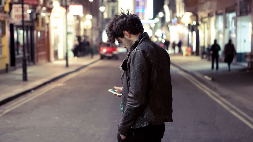 man with phone on busy street