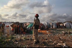 A Somali soldier looks onto a camp for people displaced by famine and drought on Aug. 19, 2011, in Mogadishu, Somalia.