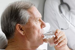 man drinking water in hospital
