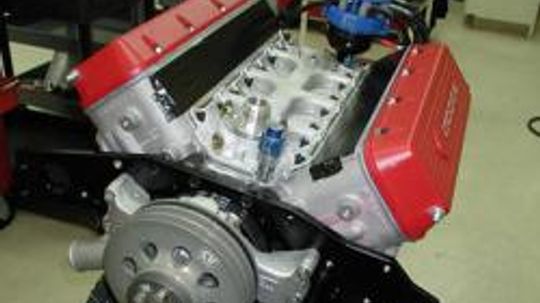 Why do some engines use a dry sump oil system?