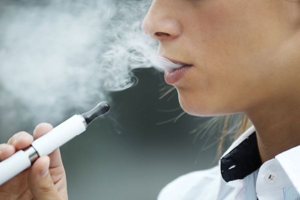 Closeup of woman smoking an e-cigarette