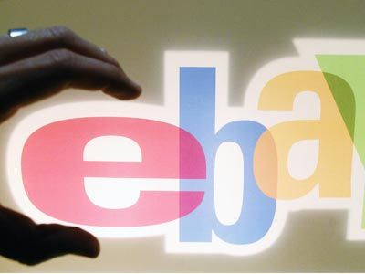 A visitor at the Trade Fair for Digital Marking in Düsseldorf, Germany, grabs the logo of Internet auction house eBay. Are organized retail crime groups grabbing profits from companies?