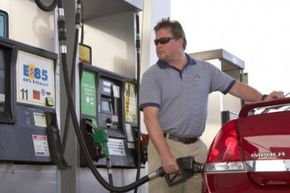 man filling up car with E85 gas