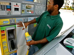 An Enterprise car rental employee gases up a Chevrolet with E85 flex-fuel in Washington, D.C. More eco-conscious consumers are demanding cars with higher gas mileage from auto rental companies. See more pictures of AFVs.