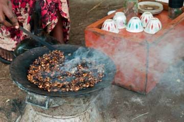 Coffee beans roasting in an open pan.