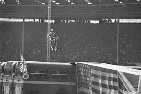 Evel Knievel approaches the landing ramp with his motorcycle during his unsuccessful effort to leap over 13 buses in London, England, on May 25, 1975.